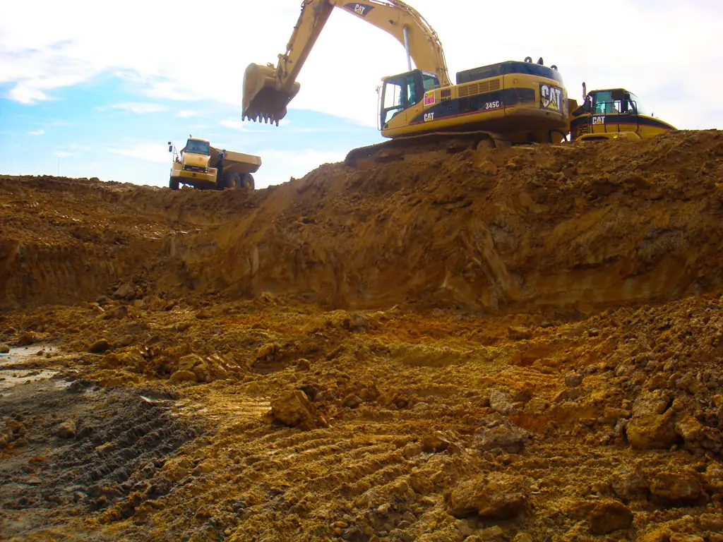 Excavators preparing a construction site, used as representative stock photography